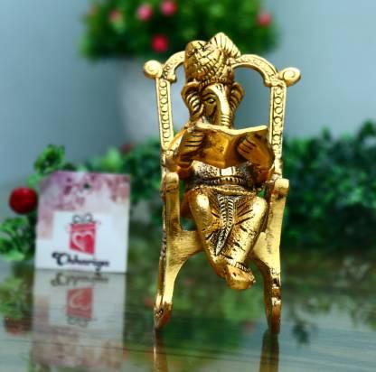 Golden Lord Ganesha Statue Sitting On A Rocking Chair And Reading Ramayan Showpiece